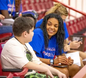 College student speaking with a child