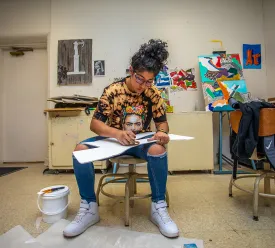 Student working on art project in the art classroom. 