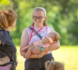 Young woman holding a baby