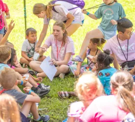 Children sitting in a circle outdoors