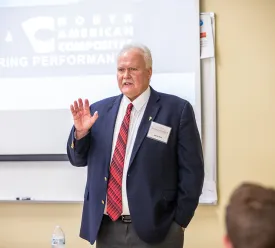 Man leading lecture in front of classroom