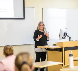 Woman giving presentation in front of a class