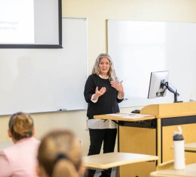 Woman giving presentation in front of a class