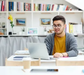 man using laptop in room