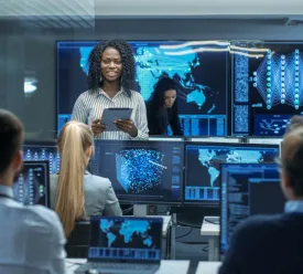 woman surrounded by computers and people