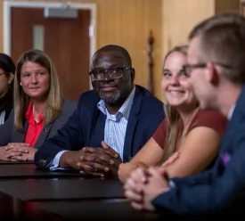 Man leads discussion among associates.