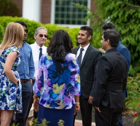 Executive students and professors talking together