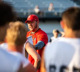 Football coach instructs players