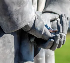 Pennies in the hands of Lincoln's statue for good luck
