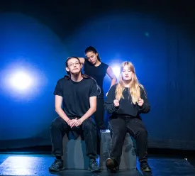Actors on dark stage