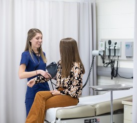 woman checks a patient's blood pressure
