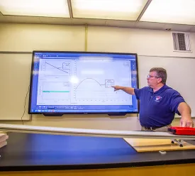 physics professor explaining a chart