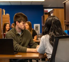 man helps lead a student through a question