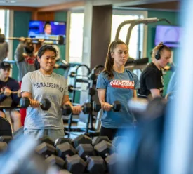 young adults working out in a weight room
