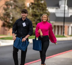 Two students prepare to join leaders at the annual business forum