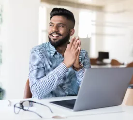 Man sitting at desk with laptop open