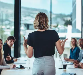 A business woman leads her team in a meeting.