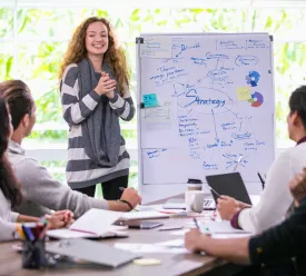 A young marketer discusses strategy with her colleagues. 