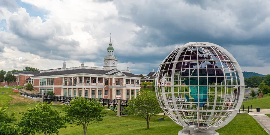 Large globe statue in front of campus building