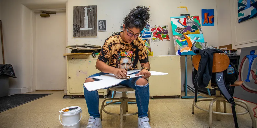 Student working on art project in the art classroom. 