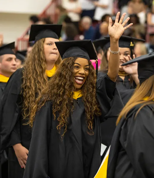 A group of Graduate students entering during the processional at Commencement.