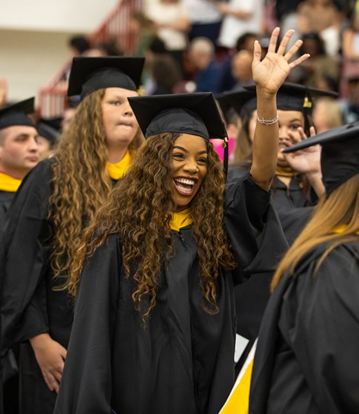 A group of Graduate students entering during the processional at Commencement.