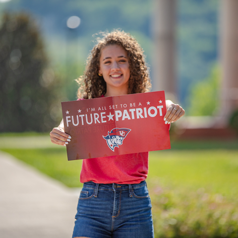 Student holding Future Patriot packet