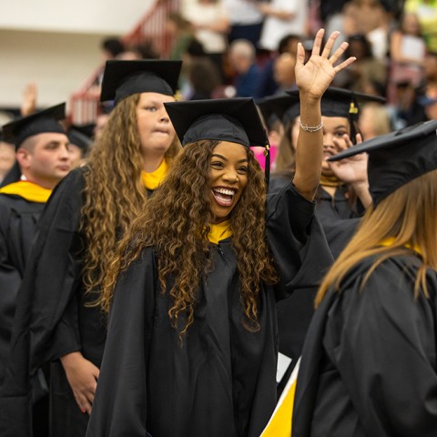 A group of Graduate students entering during the processional at Commencement.