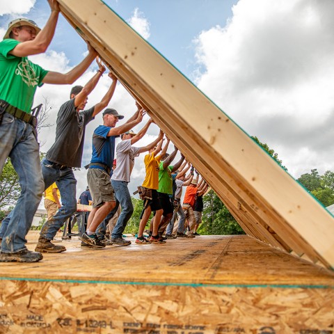 Volunteers build walls at a Mountain Outreach home