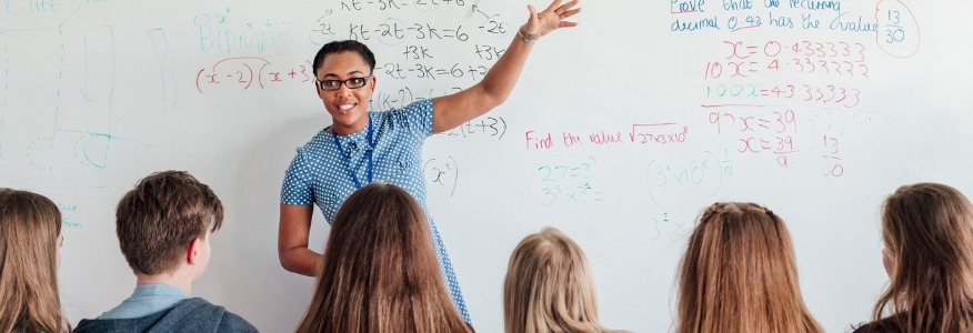 Math teacher in front of whiteboard
