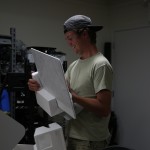 A student placing an item into styrofoam