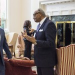 An older man speaking to a young adult