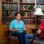 A faculty member sitting across from a student having a conversation