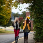 Two students on a sidewalk