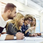 Students looking at a laptop