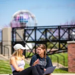 Two students having a conversation outside