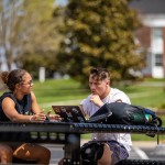 Two students looking at a laptop