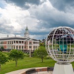 Large globe statue in front of campus building
