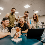Physical therapy students conduct an anatomy exercise in class. 