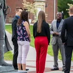 Several people standing outside having a conversation