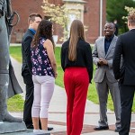 Several people standing outside having a conversation