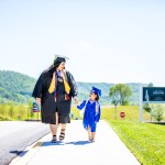 A woman and child both wearing cap and gown