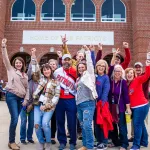 A group of alumni celebrate prior to the Homecoming football game 
