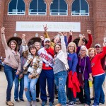 A group of alumni celebrate prior to the Homecoming football game 