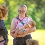 Young woman holding a baby