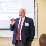 Man leading lecture in front of classroom