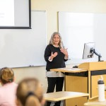 Woman giving presentation in front of a class