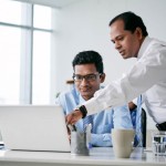 two businessmen working on a problem