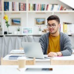 man using laptop in room