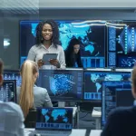 woman surrounded by computers and people